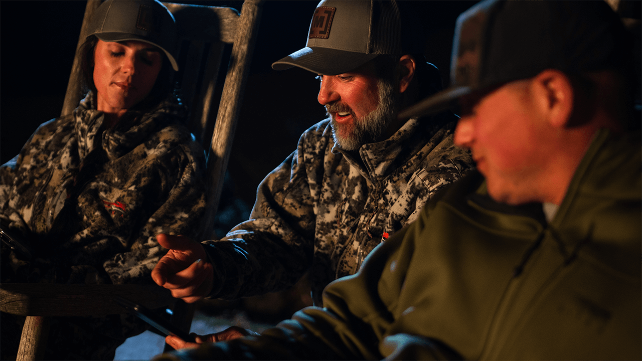 Moultrie - Three People Looking at the Moultrie App